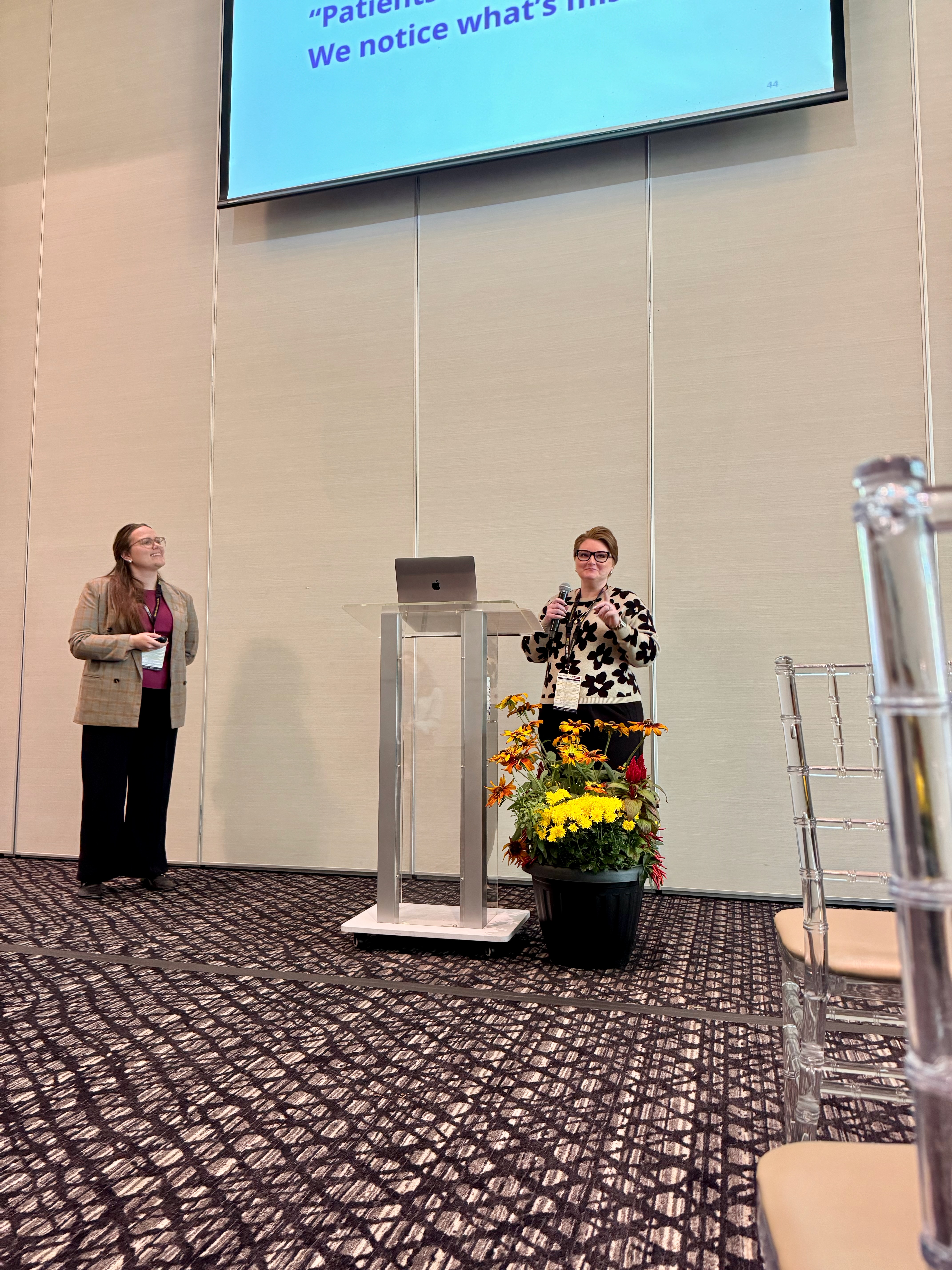 Emily Foucault speaking beside Charlotte Pape during the 2025 UHN PiPER Research Conference.